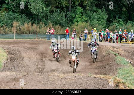 Ukraine, Romny, September 5-6, 2020: Motocross racers racing on a dirt track with spectators in the background. Ukrainian Motocross Championship. Stock Photo