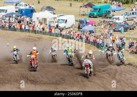 Ukraine, Romny, September 5-6, 2020: Motocross racers racing on a dirt track with spectators in the background. Ukrainian Motocross Championship Stock Photo