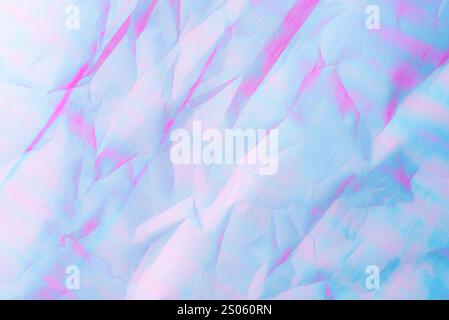 An abstract background featuring pastel hues of pink and blue with a textured crumpled paper effect. Stock Photo