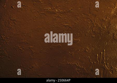 Concrete wall surface with old brown damaged paint.Dark brown concrete wall. Stock Photo