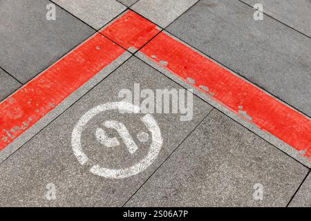 Corner of red lines and number 9 sign are on gray stone pavement Stock Photo
