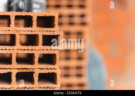 Pile of flat bricks for wall construction in masonry works. Stock Photo