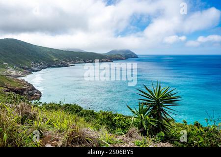 Blue water of the Atlantic Ocean around the rocky coast near Cabo Frio, State of Rio de Janeiro, Brazil. Stock Photo