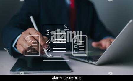 Document management man signs an electronic document on digital document by virtual notebook screen using a stylus pen, E-Document management Paperles Stock Photo