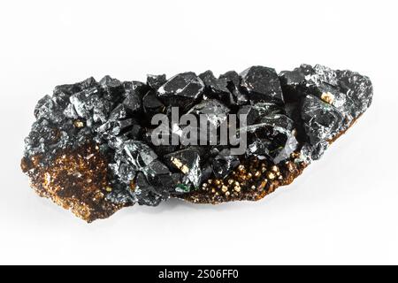 A black Lazulite Mineral rock with a greenish tint. It is shiny and has a rough texture. The rock is small and has a lot of black and green specks Stock Photo