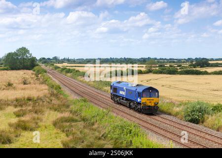 DB Cargo Rail (UK) Maritime livery class 66 diesel locomotive  passing  Church End on the Marston Vale railway line with a light engine route learner Stock Photo