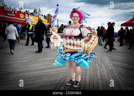Posed portrait of a professional balloon maker on the Boardwalk in Coney Island on the day of the 2020 Polar Bear New Years day swim. Stock Photo