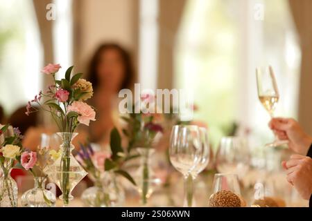 daytime banquet background with flowers and glasses Stock Photo