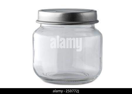 Empty small glass jar with silver colored lid isolated on white with clipping path included. Stock Photo