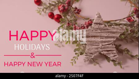Image of happy holidays and text banner over red cherries and star decoration on pink surface Stock Photo