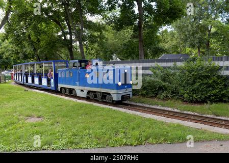 Tourists on a narrow gauge train on the Prater Liliputbahn, Prater Park,  Vienna, Austria, June 2024 Stock Photo