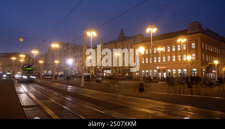 Zagreb, Croatia, October 31 2024: Green tram is moving through ban jelacic square in zagreb, croatia at dusk Stock Photo
