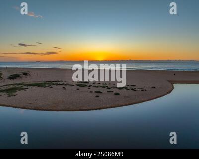 Aerial sunrise over the lagoon and beach at  Wamberal on the Central Coast, NSW, Australia. Stock Photo