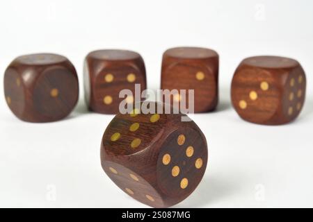 A group of five large wooden gaming dice on a white background Stock Photo