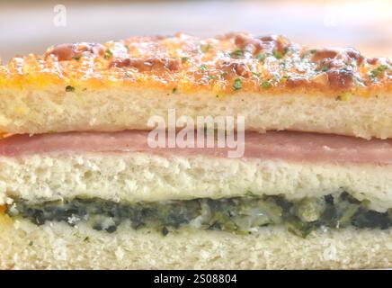 baking sandwich with cheese stuffed pork ham and mashed spinach on white background Stock Photo