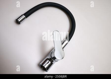 Detail of a Single lever sink mixer black spout chrome saver isolated on white background Stock Photo