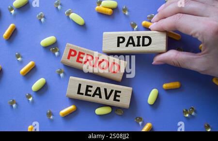 Paid Period Leave symbol. Concept words Paid Period Leave on wooden blocks. Beautiful purple background with pills. Doctor hand. Healthcare and Paid P Stock Photo