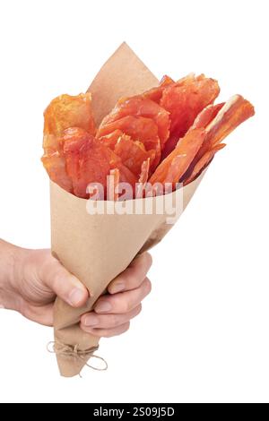 Hand holding paper bag full of pork, chicken and turkey meat chips isolated on white background Stock Photo