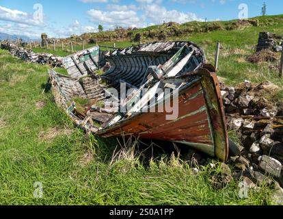 Remains of old wooden clinker built boat on the shoreline near Broadford, Isle of Skye, Scotland, UK Stock Photo