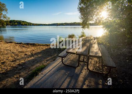 A picnic table sits next to a deserted beach on a Wisconsin lake in early October Stock Photo