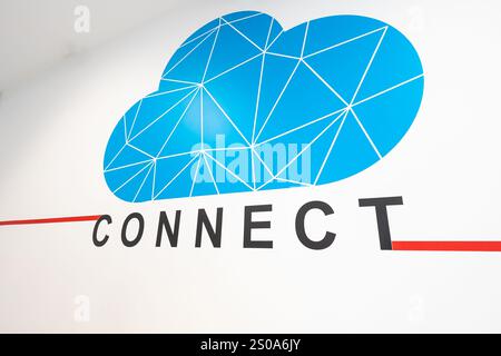 A stylized blue cloud graphic with geometric patterns adorns a white wall. Below, the word CONNECT is in bold black letters with a red line from the T Stock Photo