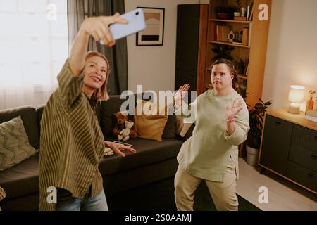 Mom And Her Daughter With Disability Having Fun At Home Stock Photo