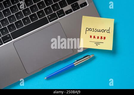 The word password written on a sticky note paper on modern laptop Stock Photo