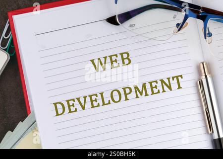 Concept word WEB DEVELOPMENT it is written in the business book in close-up, top view. Stock Photo