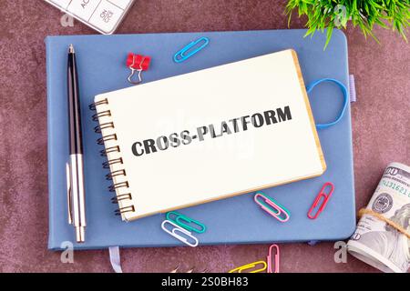 Context Marketing concept. Text CROSS-PLATFORM in the notebook, top view. Copy space. Stock Photo