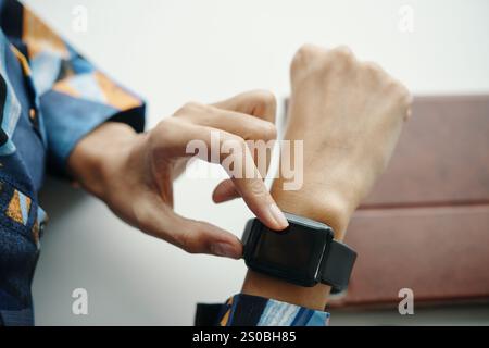 Unrecognizable Female Office Worker Using Smart Watch App Stock Photo