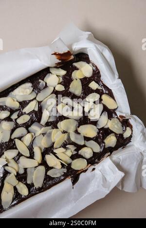 Chocolate pumpkin brownies topped with almonds before baking. Stock Photo