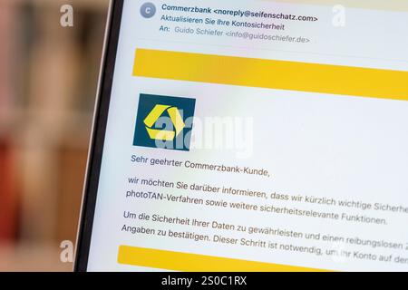 Fraudulent phishing email on a laptop reporting alleged activity on a Commerzbank account Stock Photo