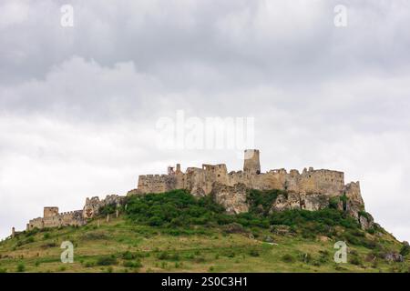 spis castle on the hill in spring. old stronghold. popular travel destination of slovakia. overcast sky. amazing vacations in eastern europe Stock Photo
