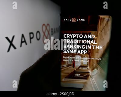 Germany. 3rd July, 2024. In this photo illustration, a person is holding a cellphone with the webpage of crypto banking company Xapo Holdings Limited in front of logo. (Credit Image: © Timon Schneider/SOPA Images via ZUMA Press Wire) EDITORIAL USAGE ONLY! Not for Commercial USAGE! Stock Photo