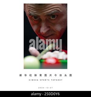 Beijing, China. 27th Dec, 2024. Ronnie O'Sullivan of England plays a shot during the match against Si Jiahui of China at 2024 Macao Snooker Masters in south China's Macao, Dec. 27, 2024. Credit: Cheong Kam Ka/Xinhua/Alamy Live News Stock Photo