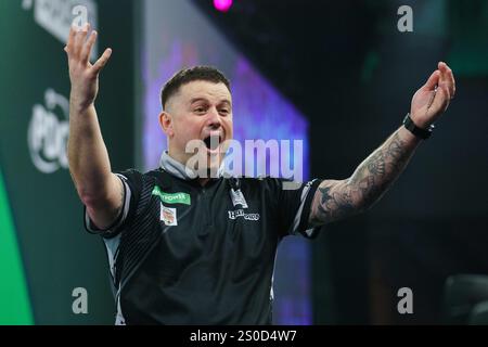 London, UK. 27th Dec, 2024. Luke Woodhouse celebrating winning his 3rd round match against Damon Heta during the PDC Paddy Power World Darts Championship 2024/2025 at Alexandra Palace, London, England, United Kingdom on 27 December 2024 Credit: Every Second Media/Alamy Live News Stock Photo