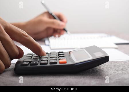 Man using calculator to count income and outcome Stock Photo