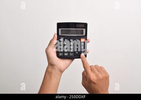 Hands holding and using a calculator isolated on a white background Stock Photo