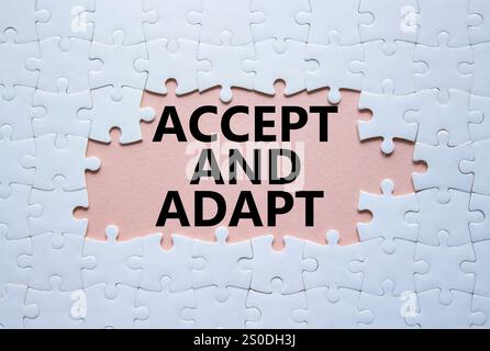 Accept or adapt symbol. Concept words Accept and adapt on white puzzle. Beautiful pink background. Business and Accept and adapt concept. Copy space. Stock Photo