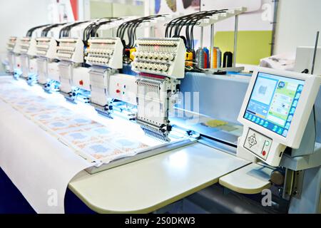 Embroidery industrial machine in sewing workshop Stock Photo