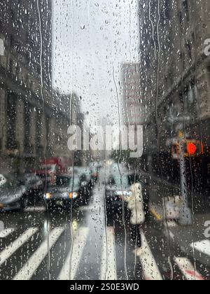 Rainy day view out the car window with water droplets on the glass ...