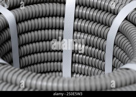 Grey, plastic corrugated pipes . Industrial background Stock Photo