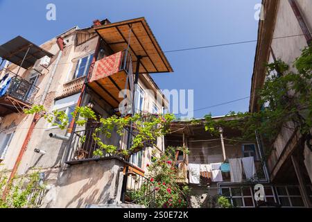 Old Tbilisi street view with balconies of small living houses on a sunny day Stock Photo