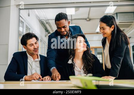 In a global meeting, a diverse team led by a female boss engages in lively discussion. Together Stock Photo