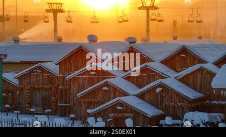 Beijing, China. 27th Dec, 2024. An aerial drone photo taken on Dec. 27, 2024 shows the scenery at dawn in a snow village scenic spot in Tuanpiaozhuang Township of Zunhua, north China's Hebei Province. Credit: Liu Mancang/Xinhua/Alamy Live News Stock Photo