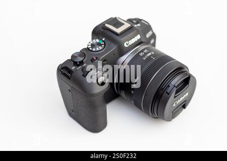 Close up of a Canon EOS R8 mirrorless camera with 24-50 mm STM lens Stock Photo