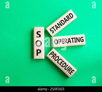 SOP - Standard Operating Procedure symbol. Wooden blocks with word SOP. Beautiful green background. Business and SOP concept. Copy space. Stock Photo