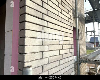 Close up of modern beige grey bricks walls at a construction site, building a house concept  Stock Photo