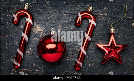 2025, 2026, Christmas and new year concept, red Christmas tree decorations on stone dark background, candy cane, red ball, star Stock Photo