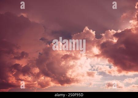 Toned Pink-yellow Clouds. Toned Cumulus Clouds Float In Blue Sky. Saturated Yellow Colors Of Clouds. . Unusual Sky Background. Rich Colors Pink Colors Stock Photo